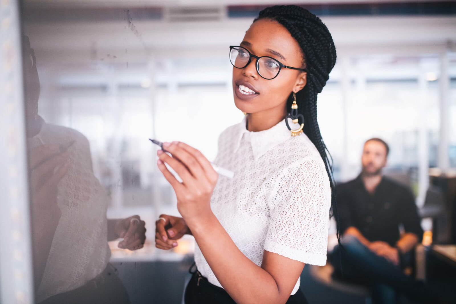 Woman writing texts on white board