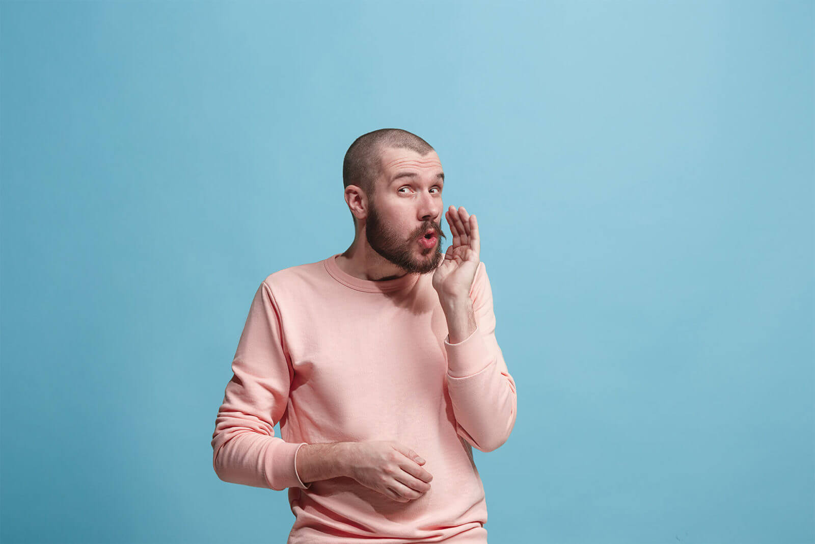 man whispering blue background about english pronunciation