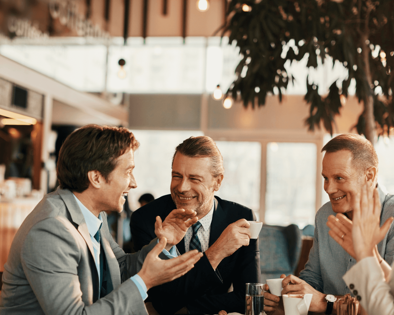 professional men talking in a coffee shop